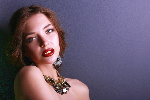 Portrait of young beautiful woman with jewelry - Foto, Imagem