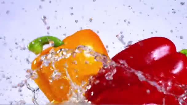 Peppers splashing in slow motion - Imágenes, Vídeo