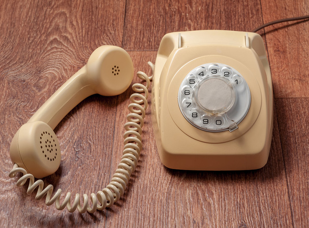 Retro telephone on wooden table in front gradient background - Photo, Image