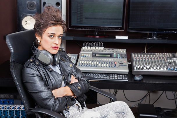 Woman Sitting With Arms Crossed At Mixing Desk - Zdjęcie, obraz