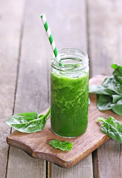 Glass of spinach juice on wooden background - Fotó, kép