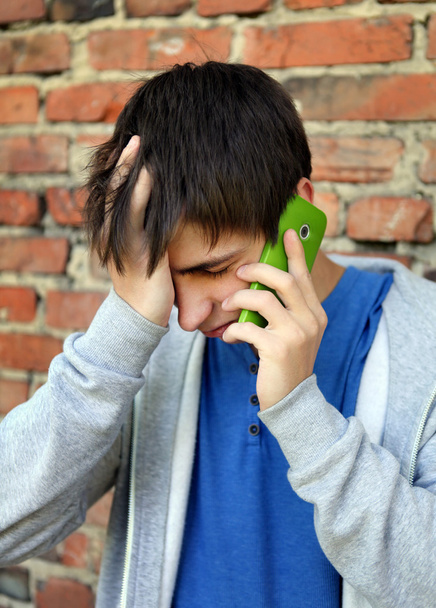 Sad Young Man with Cellphone - Foto, afbeelding