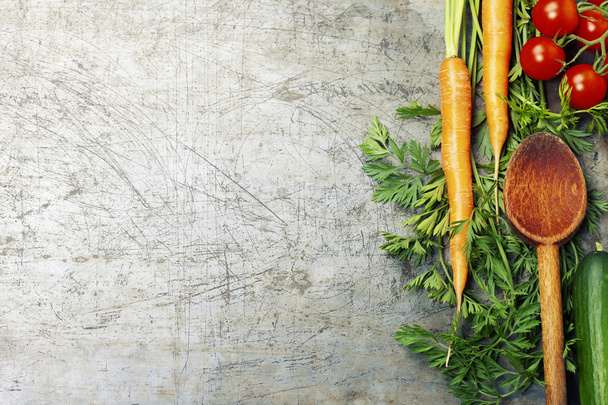 Wooden spoon and ingredients on old background. Vegetarian food, health or cooking concept - 写真・画像