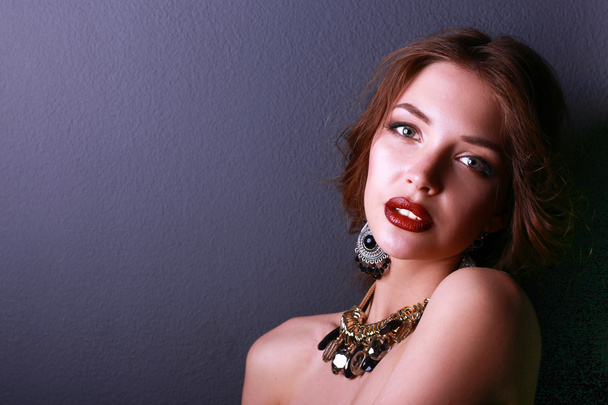 Portrait of young beautiful woman with jewelry - 写真・画像