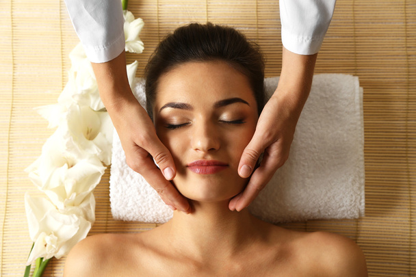 Young woman in beauty spa salon enjoying head massage - Photo, Image
