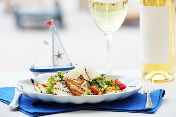 Tasty salad with served wine on blue napkin - Foto, Imagem