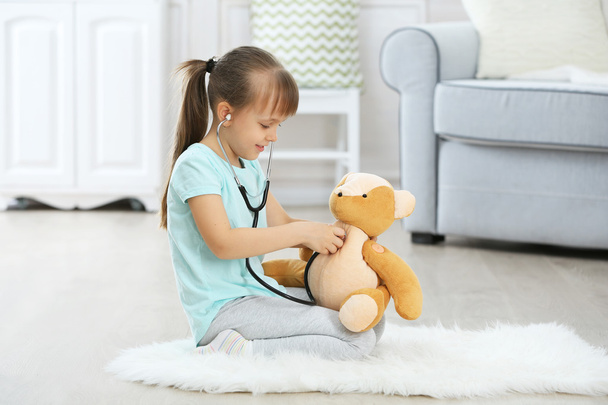 girl with stethoscope and bear - 写真・画像