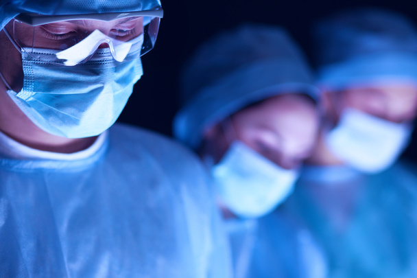 Team surgeon at work in operating room. - Фото, изображение