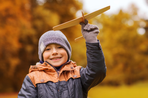 happy little boy playing with toy plane outdoors - Zdjęcie, obraz
