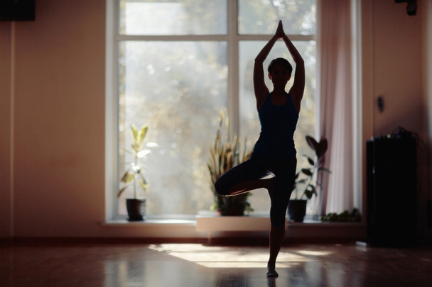 fitness girl yoga silhouette in the room - Фото, изображение