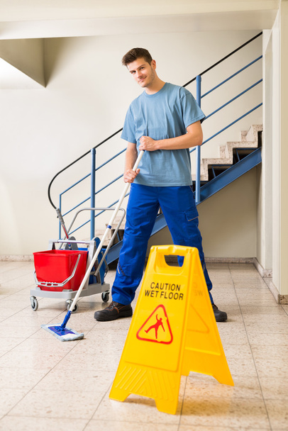 Male Janitor Mopping Floor - 写真・画像