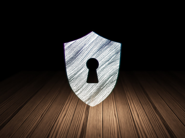 Security concept: Shield With Keyhole in grunge dark room - Photo, Image