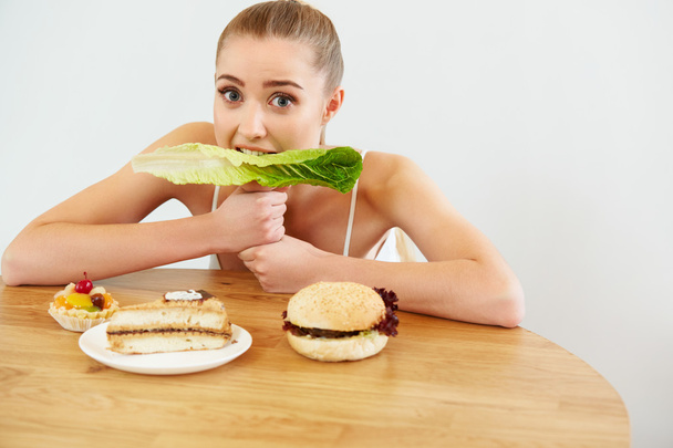 Diet concept. Beautiful Young Woman eats Lettuce - Zdjęcie, obraz