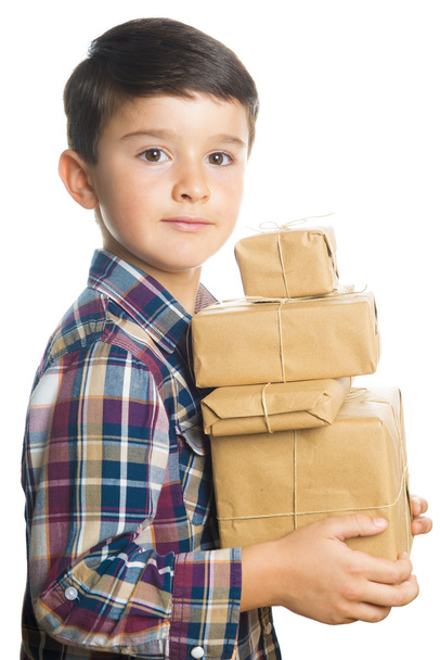 Child carrying Christmas gifts - Foto, Imagen