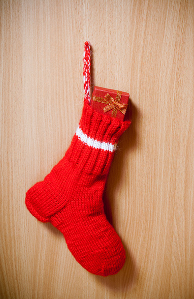 Winter warm sock with christmas gift on wooden background - Photo, Image