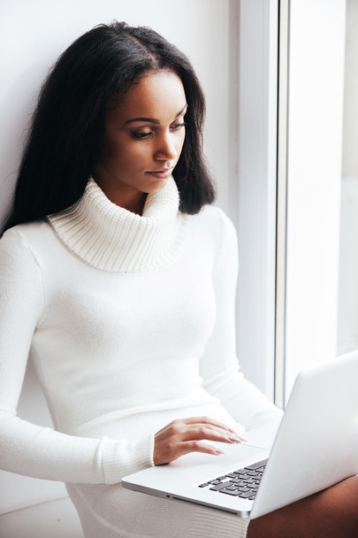 woman in warm sweater working on laptop - Photo, Image