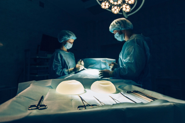 Surgeons team working with Monitoring of patient in surgical operating room.breast augmentation. - Valokuva, kuva