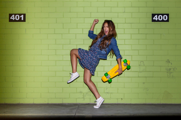 hipster beautiful girl with skateboard - Fotó, kép