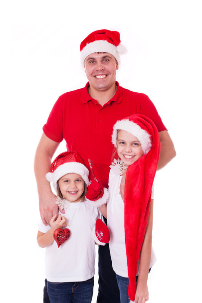 Happy  father and two daughters in santa's hats laughing - Foto, Bild