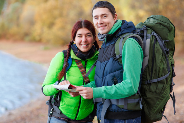 Happy couple going on a hike together in a forest - Photo, Image