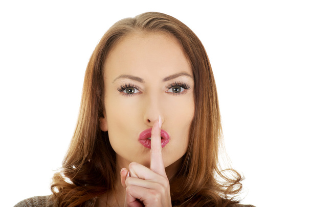 Woman placing finger on lips. - Photo, Image