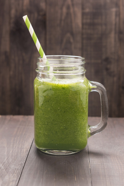 Healthy green vegetables and green fruit smoothie on rustic wood - Фото, зображення