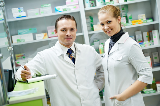 Pharmacy chemist team women and man in drugstore - Foto, Imagen