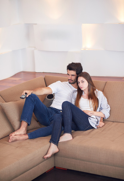 young couple watching tv at home - Foto, Imagem