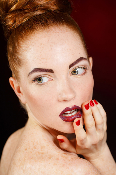 Studio portrait of a redhead female model. - Фото, изображение