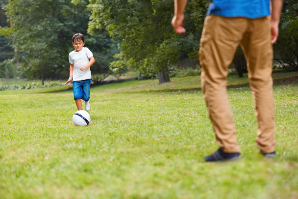 Family playing football. Father and son having fun. - 写真・画像