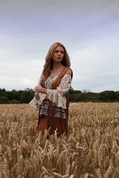 Beautiful teenage girl standing in a meadow - 写真・画像