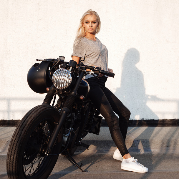 Biker girl sitting on vintage custom motorcycle - Photo, Image