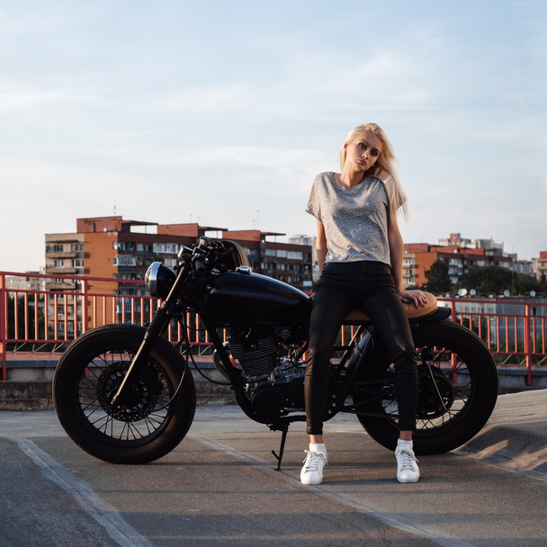 Biker girl sitting on vintage custom motorcycle - Photo, Image