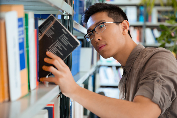 Man searching book in library - Photo, image