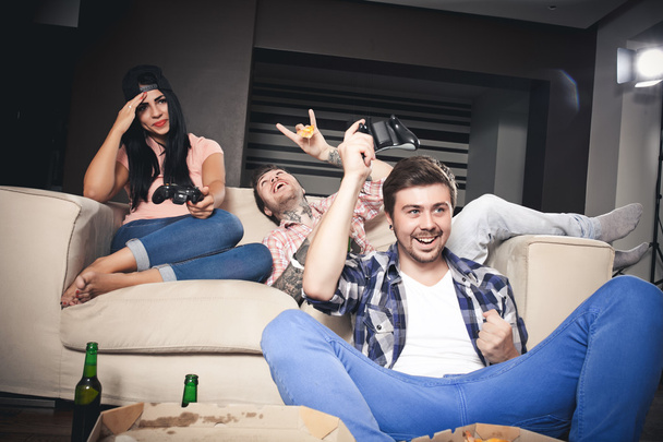 playing video games while sitting on sofa - Foto, Bild