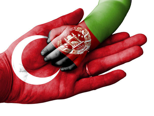 Adult man holding a baby hand with Turkey and Afghanistan flags overlaid. Isolated on white - Fotografie, Obrázek