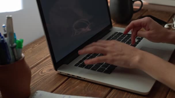Woman working with laptop placed on wooden desk - Filmmaterial, Video
