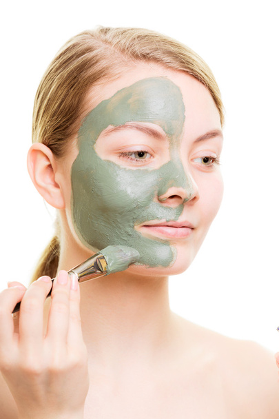 Woman applying with brush clay mud mask her face - Φωτογραφία, εικόνα