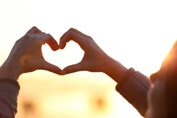Ruce ve tvaru srdce lásky na pozadí slunce - Fotografie, Obrázek