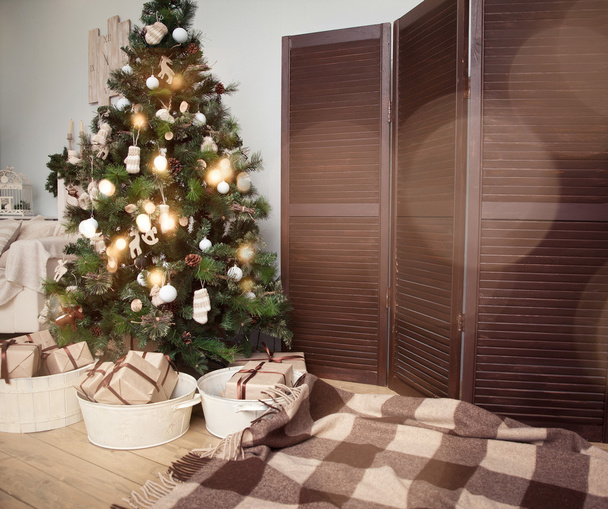 Karácsonyfa ajándékokkal a nappali alatt - Fotó, kép