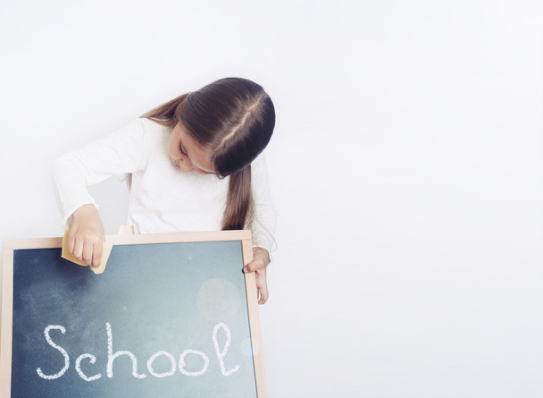 cute lovely school girl holding chalkboard, education concept - Photo, Image