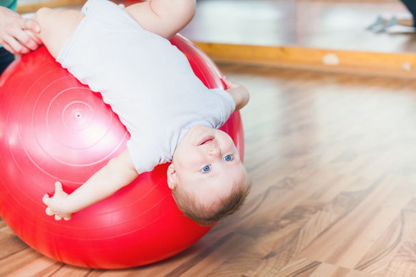 Mother with happy baby doing exercises with gymnastic ball - Foto, Bild