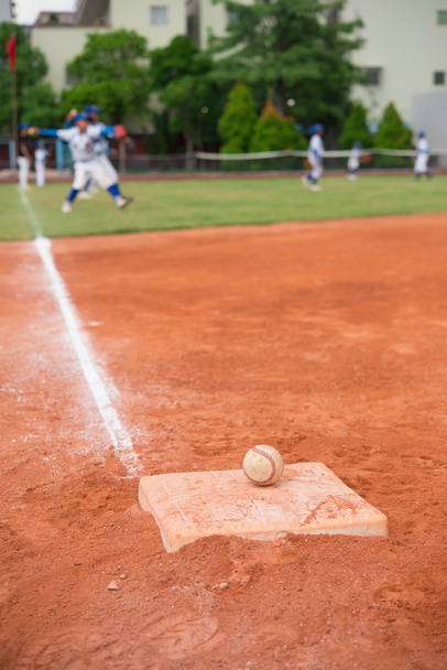 baseball and base on baseball field with players on background - Zdjęcie, obraz