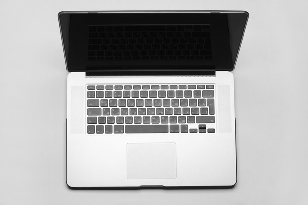 Beautiful gray laptop for work on white background in studio top view - Φωτογραφία, εικόνα