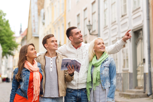 group of friends with city guide exploring town - Foto, Imagen