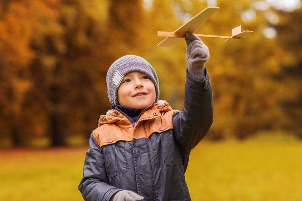 happy little boy playing with toy plane outdoors - Foto, imagen