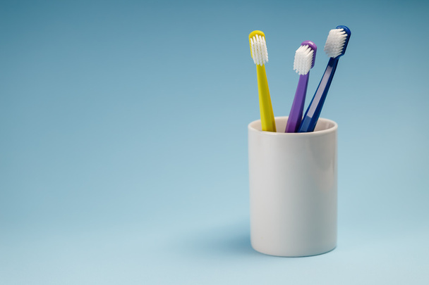 Toothbrushes in a ceramic holder - 写真・画像