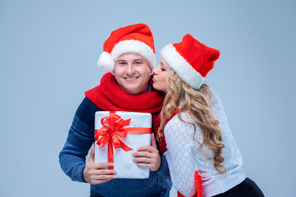 Lovely christmas couple holding presents - Fotografie, Obrázek