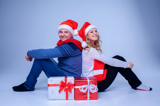 Lovely christmas couple sitting with presents - Fotoğraf, Görsel
