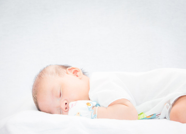 Peaceful baby lying on a bed while sleeping. - Foto, immagini